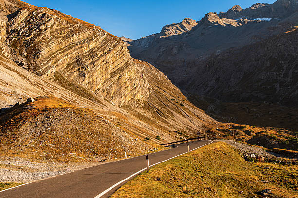 autumnal mountain sunset inside the Stelvio National Park along the road to the Stelvio Pass on the Lombard side, Sondrio, Italy