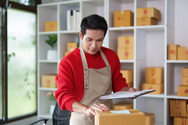 istock Small Business Owner Organizing Packages for Delivery 2225330905