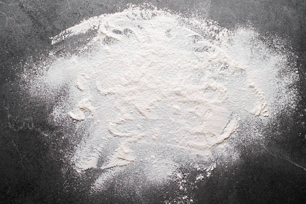 istock Flat lay cooking background of flour laying on slate board with copy-space. 2225331775