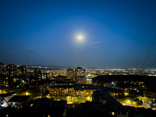 istock A city at night with a full moon in the sky 2225332828