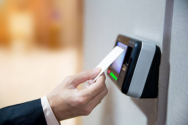 istock Proximity card reader door unlock, Close up hand security man using ID card scanning at the access control system for identity verification to open the door or for security safety or check attendance. 2225333616