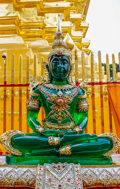 istock Emerald Buddha statue in ornate temple setting, gold decorations and intricate details 2225333751