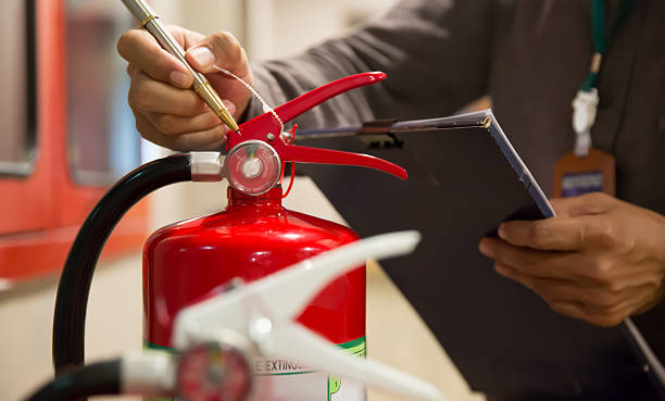 istock Fire extinguishers with firefighter checking in building for protection and prevent for emergency and safety rescue and fire training. 2225333757