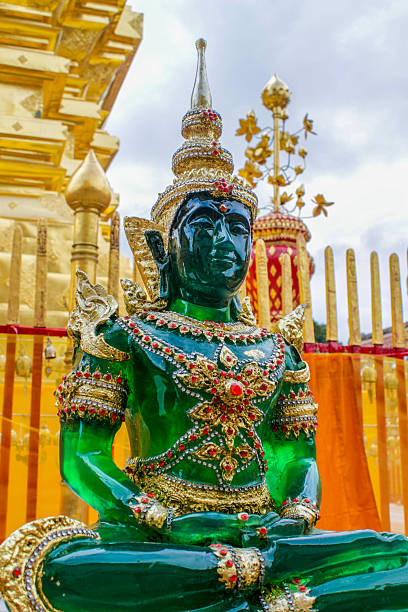 istock Emerald Buddha statue in ornate temple setting, gold decorations and intricate details 2225333856