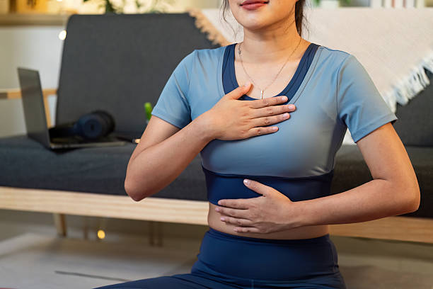 istock Mindfulness and Wellness. Woman practicing deep breathing and meditation at home. 2225333991