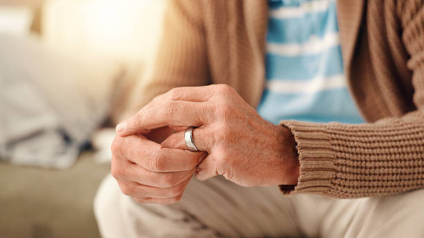 istock Hands, home and old man with doubt, ring and toxic relationship with divorce, sad and confused. Pensioner, apartment and elderly person with closeup, frustrated and conflict with anxiety and crisis 2225338615