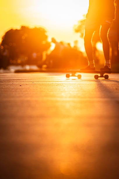 Man riding a longboard with his friends at night