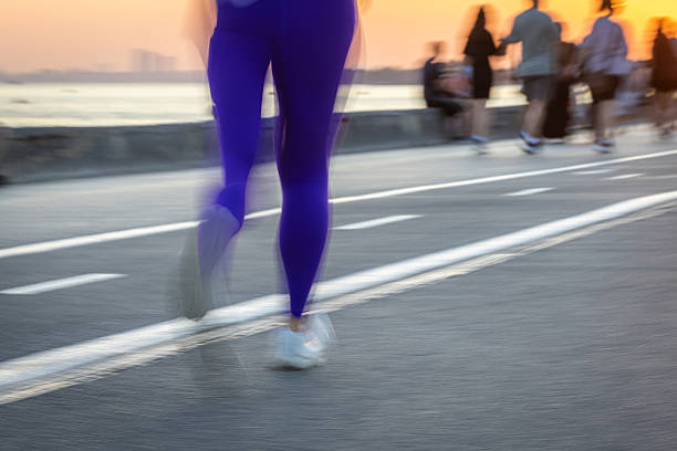 Young woman with purple leggings is jogging at sunset.\nIstanbul - Turkey.