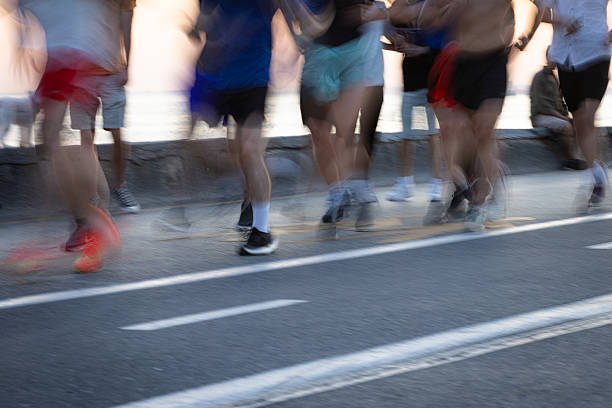 istock People are jogging together in public park at sunset. 2225340709