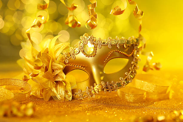 istock Beautiful carnival mask on golden shiny surface, closeup 2225342173