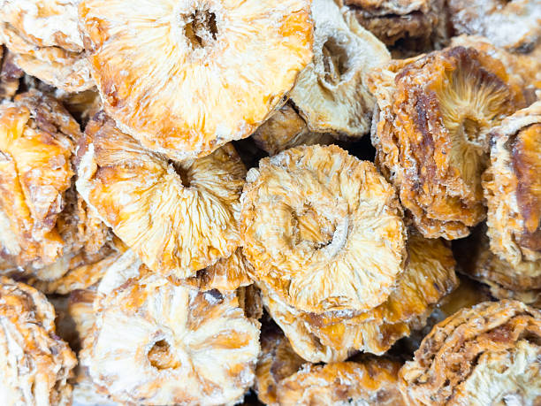 istock Dried pineapple slices piled together in close up view 2225342245