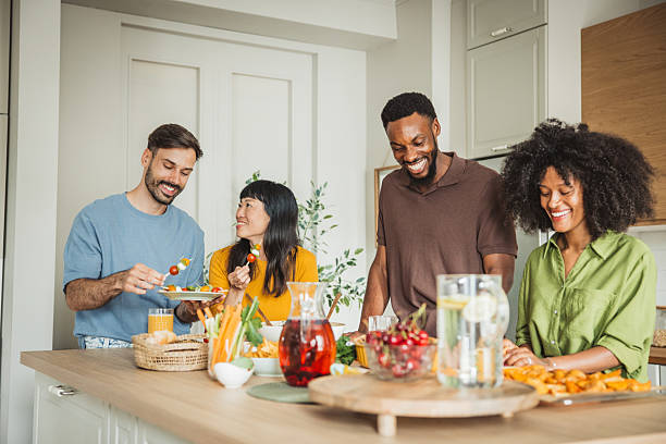 istock Friends preparing a meal together 2225342368