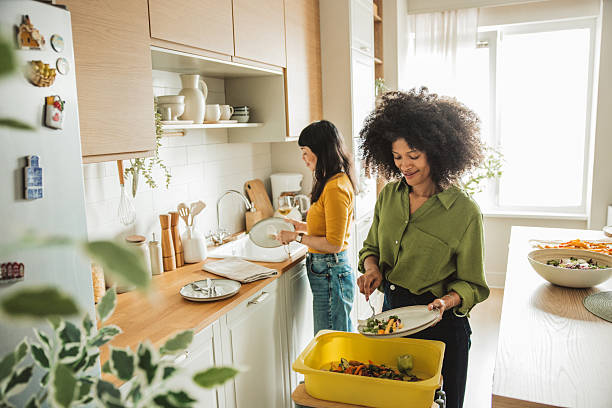 istock Friends doing dishes after  dinner party 2225342891