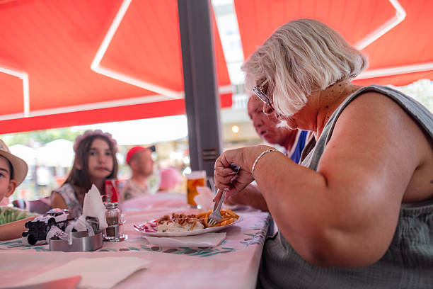 istock Older woman eating gyros 2225345918