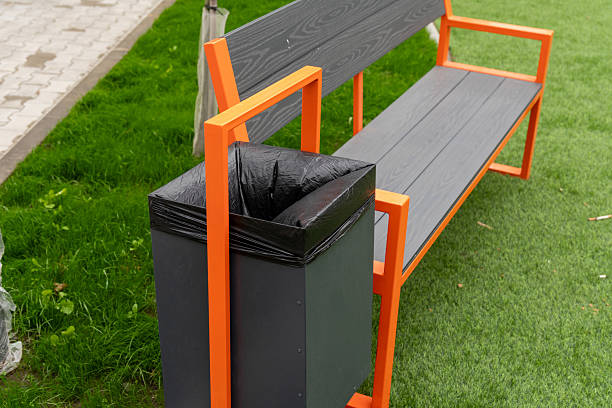 istock A modern bench with bright orange accents is situated next to a trash bin, enhancing the park's functionality and aesthetic appeal 2225346375