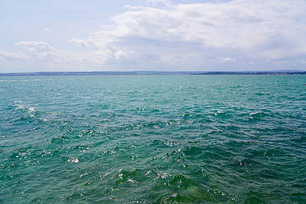 Thunderclouds over the lake. A storm is approaching the water. The water is choppy. Waves on the lake.