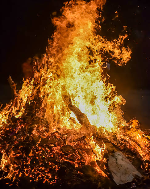 istock Fire flames on black background, Blaze fire flame texture background, Beautifully, the fire is burning, Fire flames with wood and cow dung bonfire 2225347593