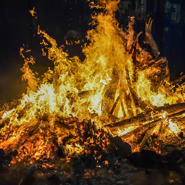 istock Fire flames on black background, Blaze fire flame texture background, Beautifully, the fire is burning, Fire flames with wood and cow dung bonfire 2225347594