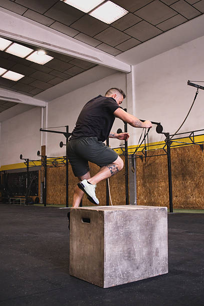 istock Middle-aged man jumping on box in modern gym 2225348662