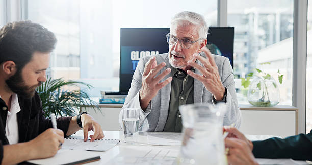 istock Discussion, boss and group meeting in boardroom, collaboration or communication for global trade. Team, mature man and negotiation for international investment, people and economic trends in business 2225349199