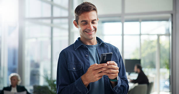 istock Typing, creative and business man with phone in office for networking, text message or brand specialist online. Mobile, startup and happy worker reading email, campaign and promotion on social media 2225349361