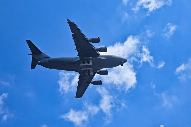 istock Large airplane soaring through a clear blue sky. 2225352292