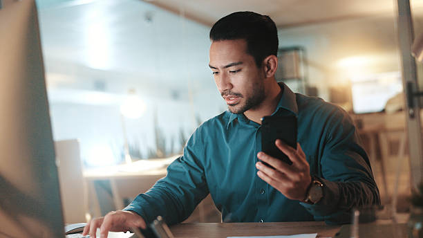 istock Night, computer and man with smartphone, typing and email for proposal, proofreading and deadline. Evening, person and journalist in workplace, cellphone or pc with internet, website info or research 2225352449