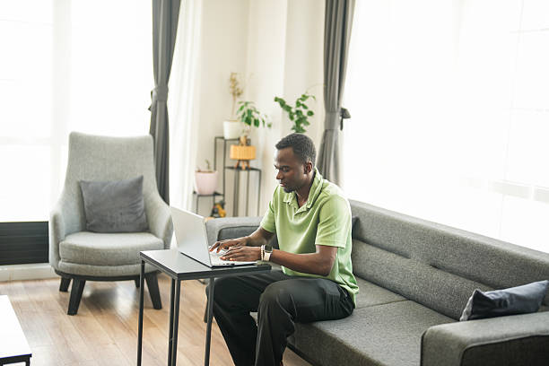 istock Young African Man Working from Home with Laptop 2225354218