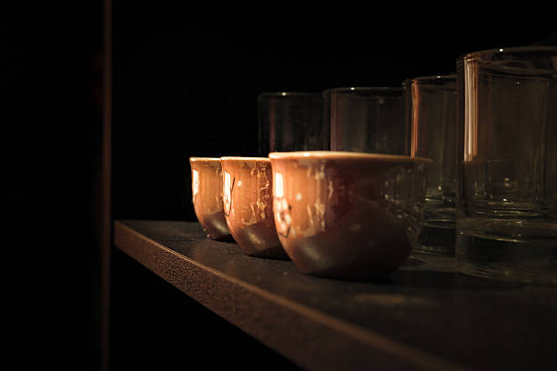 A row of small ceramic bowls in low light