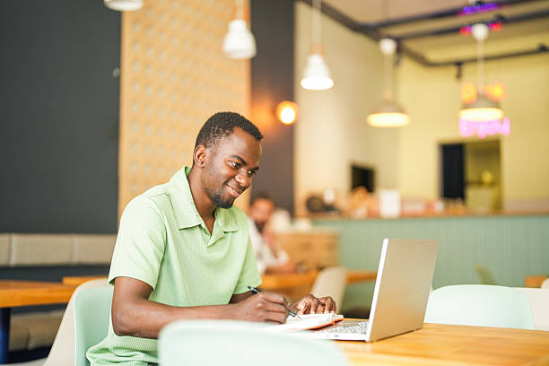 istock Young African American Entrepreneur Working Online with Iced Coffe 2225354950