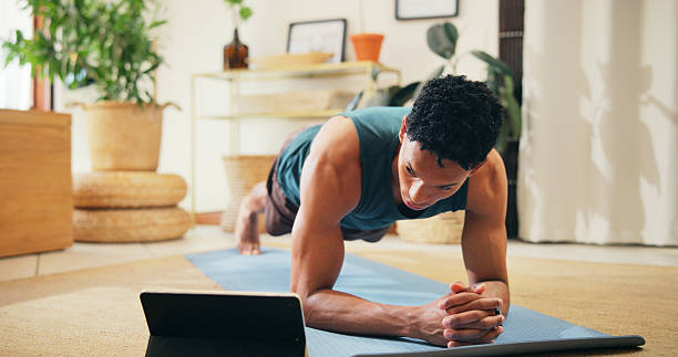istock Man, tablet and fitness tutorial for plank exercise, online course or balance with strong core muscle. Streaming, lounge and male person in virtual class for abs, workout program or training in home 2225356230