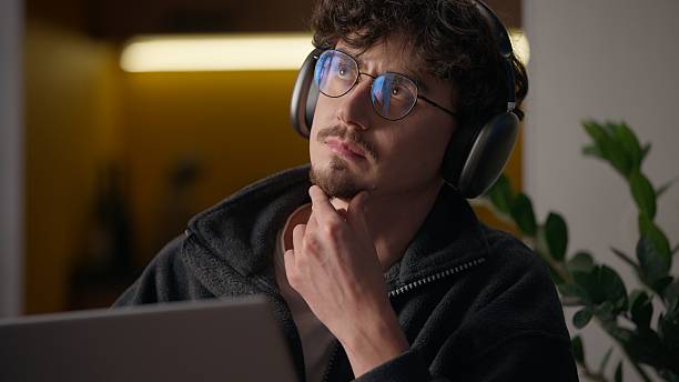 istock Thoughtful Hispanic guy thinking typing keyboard laptop at home programmer man working remote business freelancer searching information website cyberspace broker male looking gadget pc contemplating 2225357062