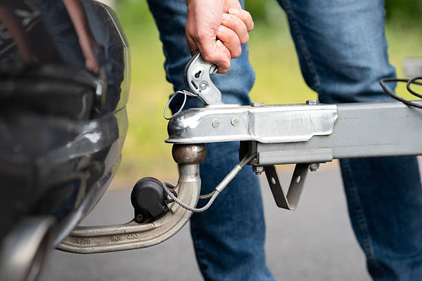 istock Pulling the Lever of the Hitch Coupling to Connect the Trailer 2225358897