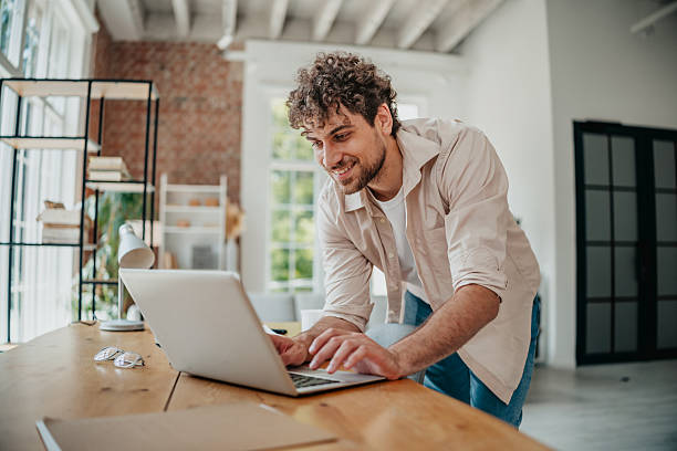 istock Young man working intently from home in a modern living space 2225359701