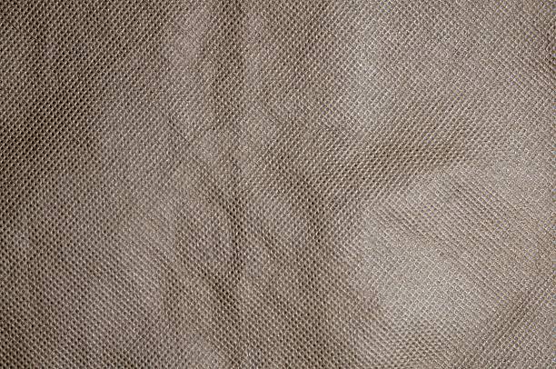 istock This image showcases a textured, woven fabric with a repeating diamond pattern in earthy tones. 2225360726