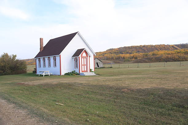 Gypsumville, Manitoba, July18, 2023 :  The Gypsumville United Church stands quietly in the heart of Manitoba, its whitewashed walls glowing beneath the summer sun - a timeless symbol of community, faith, and prairie resilience.