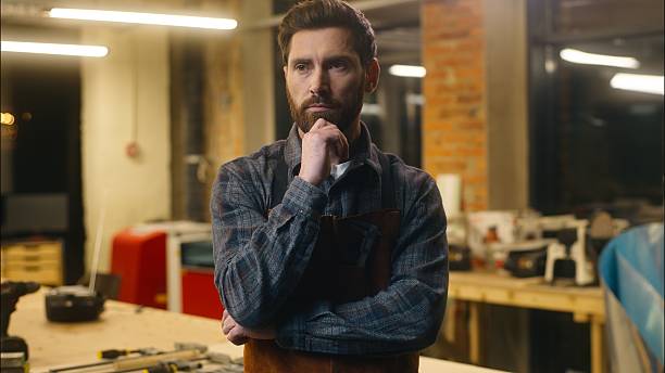 istock Professional pensive Caucasian carpenter guy worker measure hardwood ruler tool builder male woodwork art in workshop craftsman man work artist write measurement notebook wood master think carpentry 2225362067