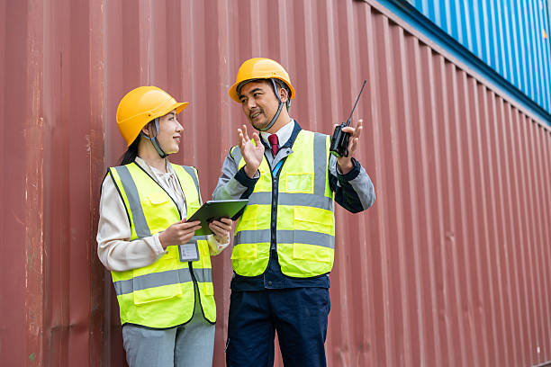 istock Teams of Asian logistics engineers having a discussion at a cargo container yard about supporting relevant departments in carrying out cargo handling operations. 2225364259