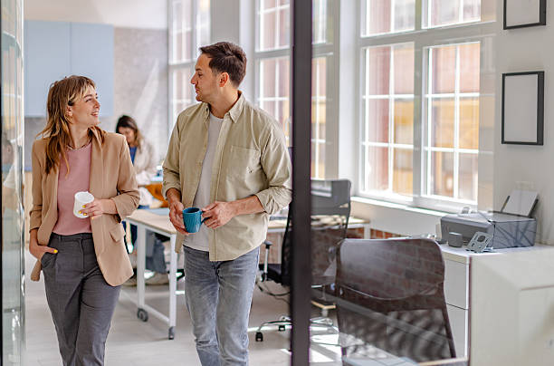 istock Colleagues discuss project ideas while walking through a modern office space in the afternoon 2225364269