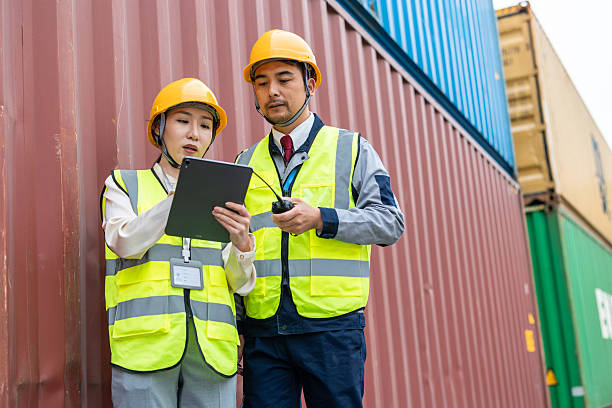 istock Teams of Asian logistics engineers having a discussion at a cargo container yard about supporting relevant departments in carrying out cargo handling operations. 2225364315