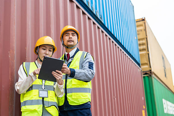 istock Teams of Asian logistics engineers having a discussion at a cargo container yard about supporting relevant departments in carrying out cargo handling operations. 2225364331
