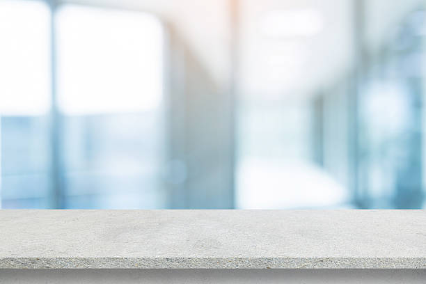 istock Abstract blurred  interior modern office room background with perspective cement quartz table for show, promote and design content or product on display concept 2225365257
