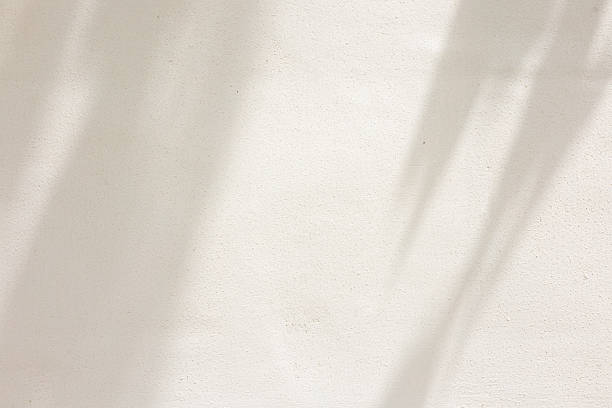 istock close up on beige plain wall background texture with shadow of window from sunlight for ads and advertisement product such as cosmetic or content or goods design display concept 2225365297
