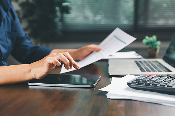 istock Office businesswoman hand to operate calculator analyzing financial data, counting costs on desk. accounting, financial analysis for business budget planning, calculation support, finance management. 2225365546