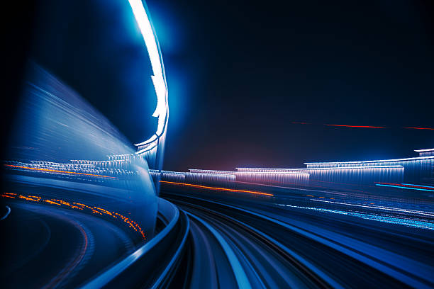 High-Speed Motion Blur Captured on a Nighttime Futuristic Monorail Ride