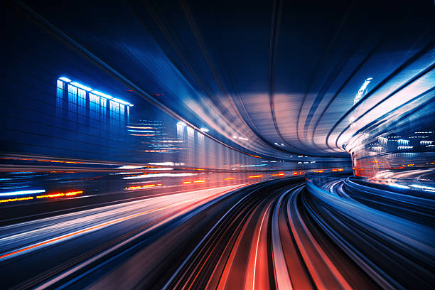 Dynamic Motion Blur Scene of a High-Speed Monorail in Tokyo at Night stock photo