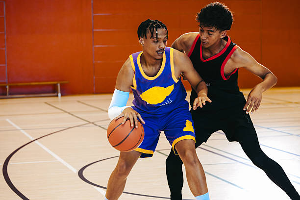 istock One-on-one: Guard takes on defender at top of key 2225370342