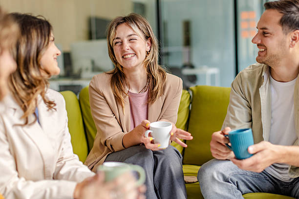 istock Office team members engage in a collaborative meeting discussing projects and strategies in a modern workspace with vibrant decor 2225370439