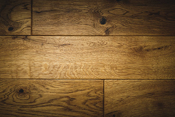 Detailed view of wooden planks showing rich texture and natural grain in warm tones. This image highlights the beauty of wood, ideal for themes like interiors, craftsmanship, or backgrounds.