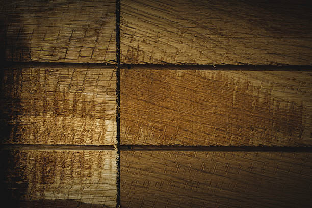 Detailed view of wooden planks showing rich texture and natural grain in warm tones. This image highlights the beauty of wood, ideal for themes like interiors, craftsmanship, or backgrounds.